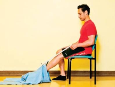 Man using a long handled reacher to get dressed
